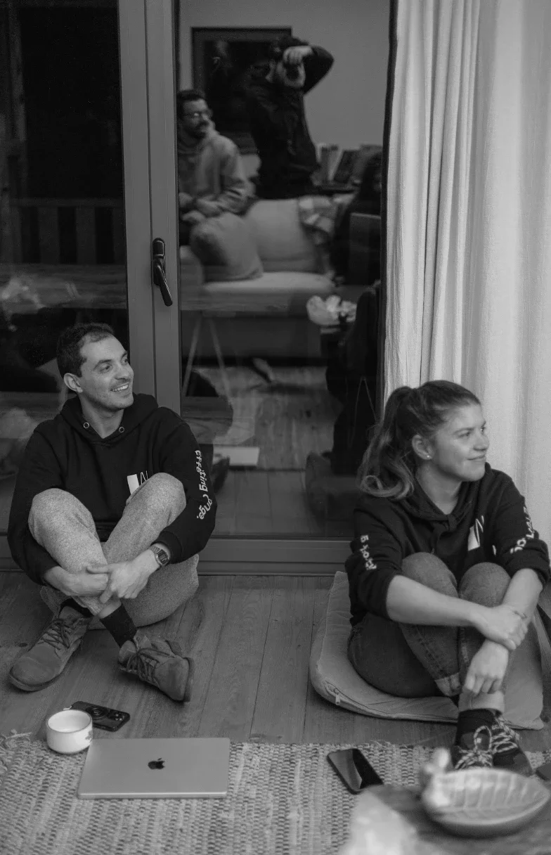 Two Whitesmith team members sitting on the floor at a retreat